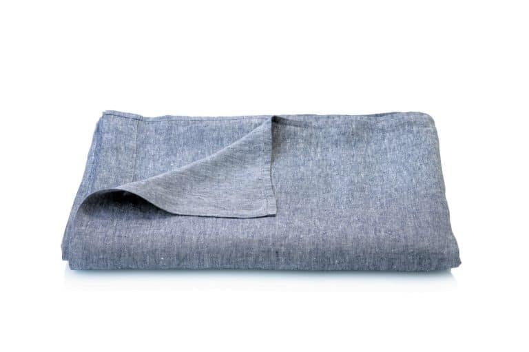 Ein ordentlich gefaltetes Heron Leinen Bettlaken von Geniksa in hellgrau, mit einer teilweise umgeschlagenen Ecke, ist auf weißem Hintergrund abgebildet.