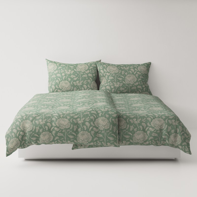 A bed with a green comforter and two pillows.