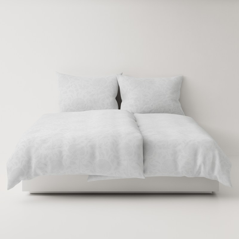 A bed with a white comforter and two pillows.