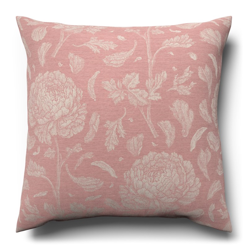 A pink cushion with white flowers on it.