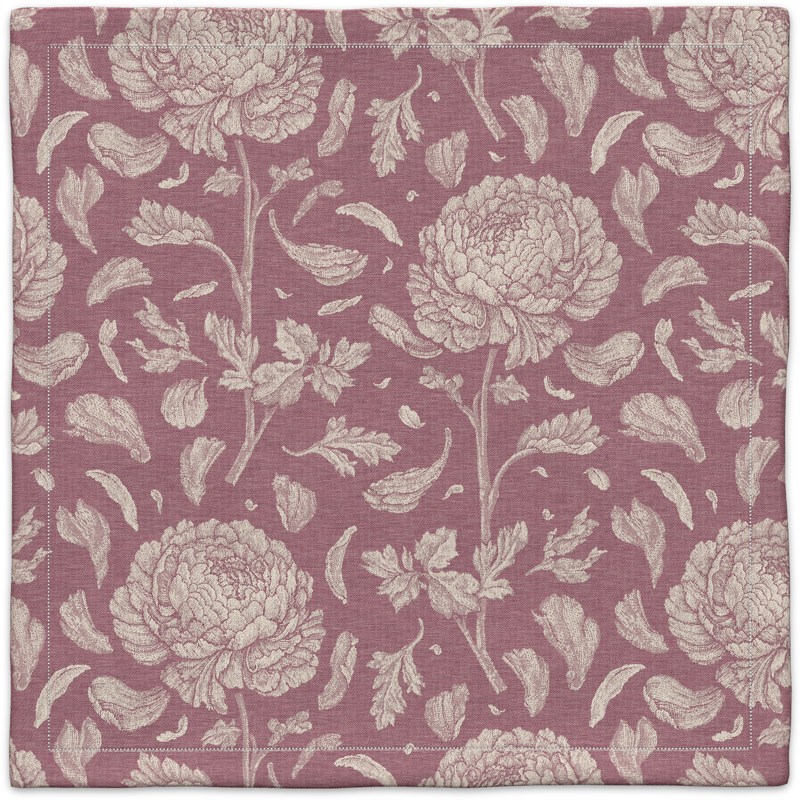 A pink and white floral pattern on a linen napkin.