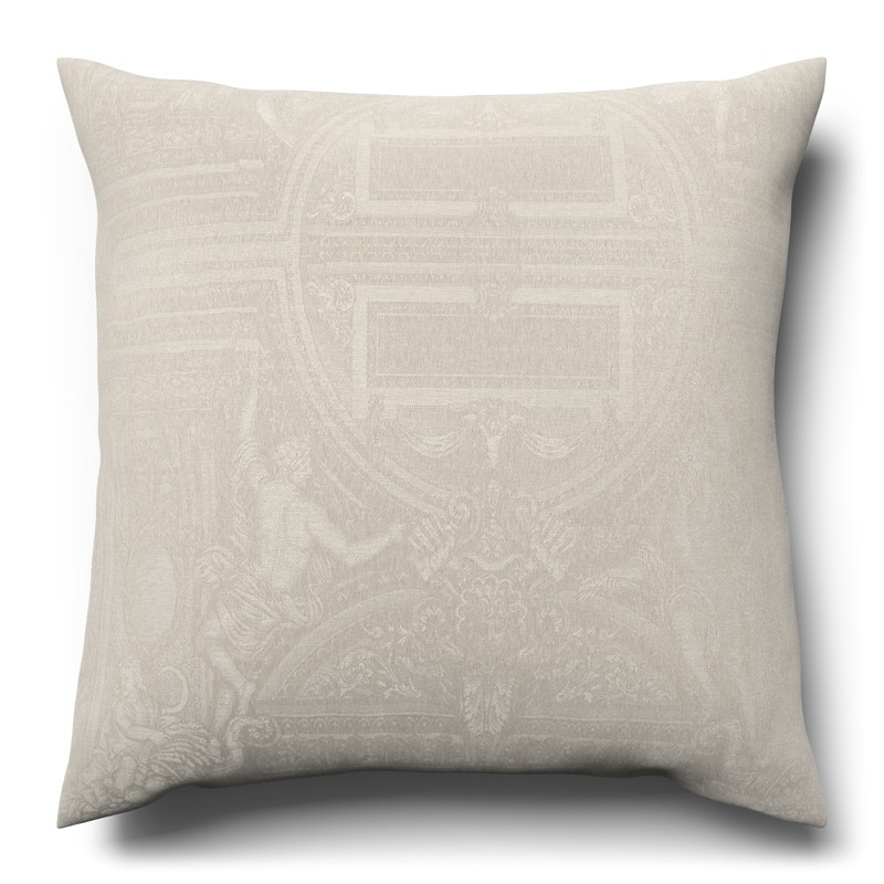 A white cushion with a decorative pattern on it.