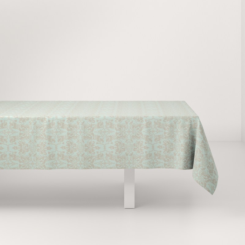 A white table with a green tablecloth on it.