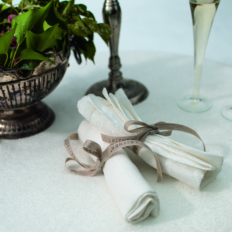 A table with a vase filled with flowers.