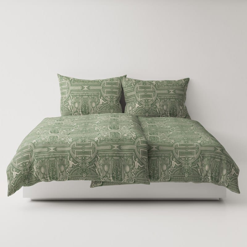 A bed with a green comforter and two pillows.