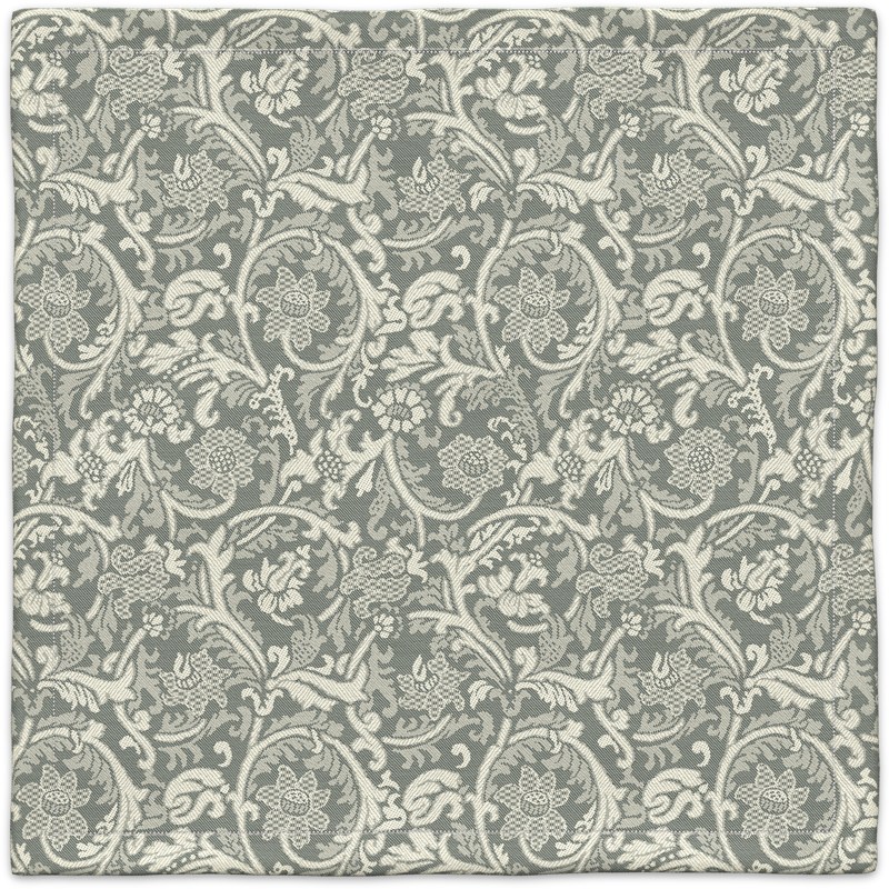 A gray and white carpet with a floral pattern.
