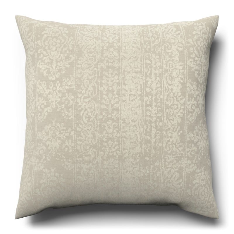 A white cushion with a pattern on it.