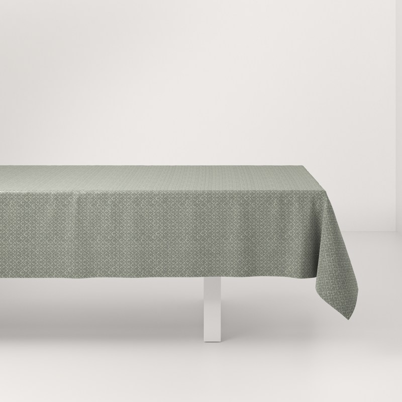 A table with a green tablecloth on it.