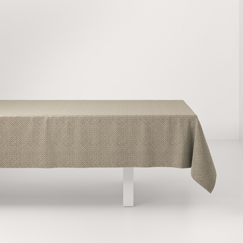 A white table with a beige tablecloth on it.