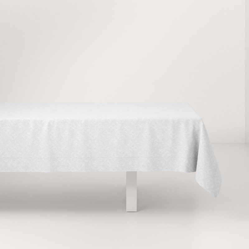 A white table with a white tablecloth on it.