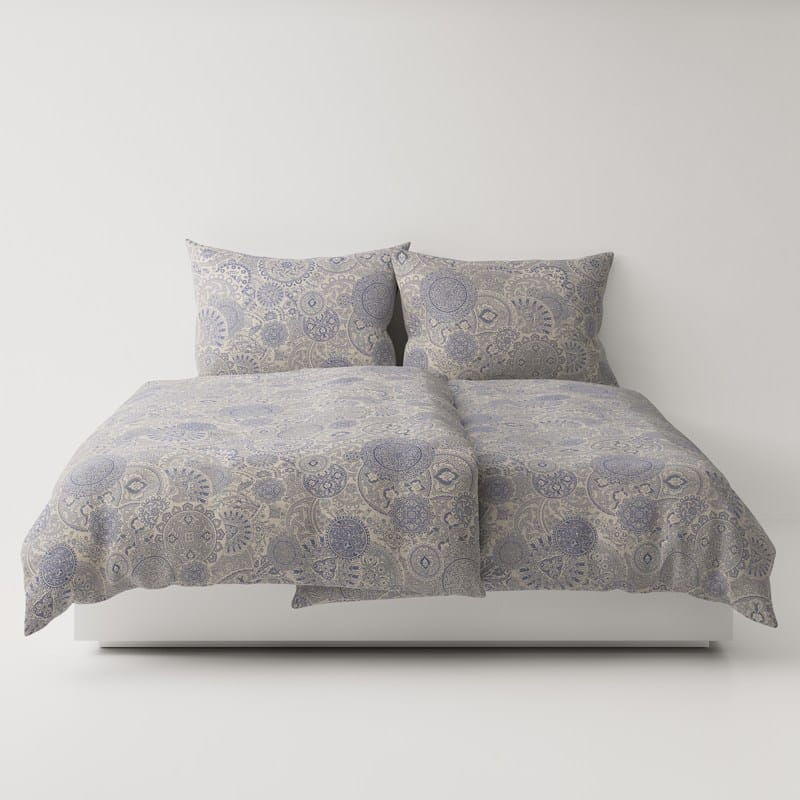 A bed with two pillows and a comforter.