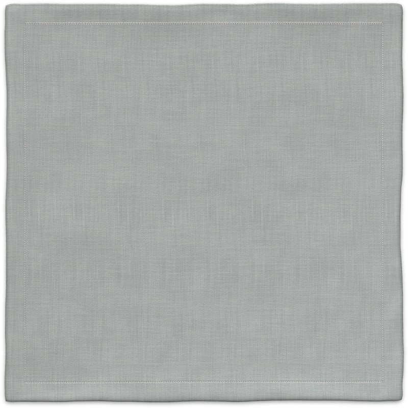 A placemat made of light gray linen with a white border.
