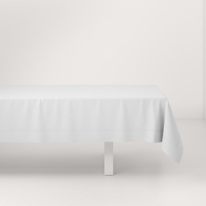 A white table with a white tablecloth on it.