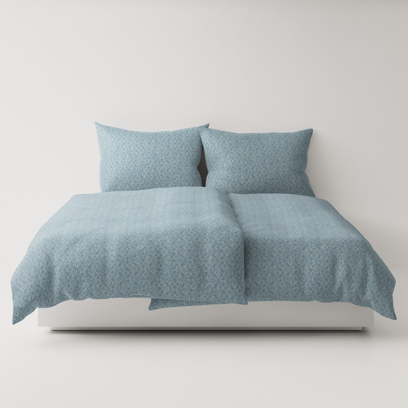 A bed with a blue comforter and two pillows.