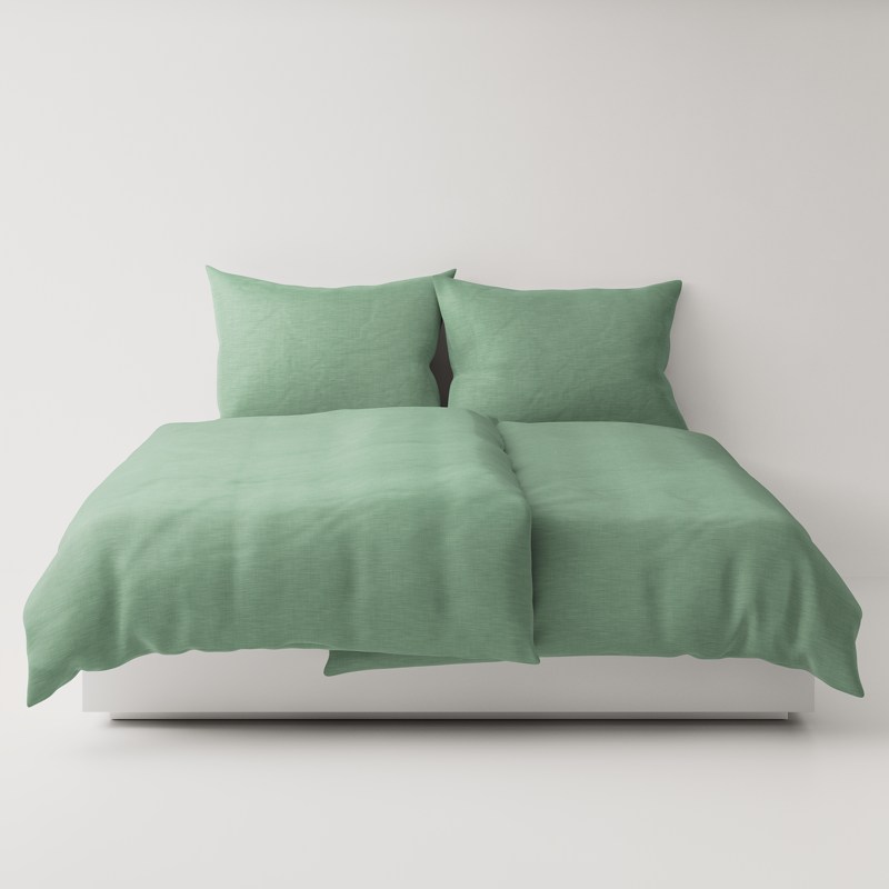 A bed with a green comforter and pillows.