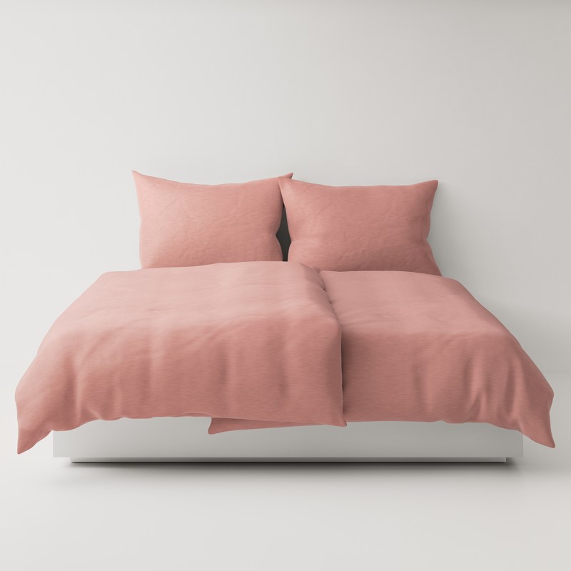 A bed with a pink comforter and two pillows.