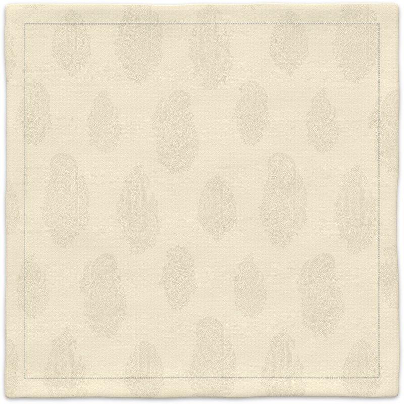 A white placemat with a paisley pattern on it.