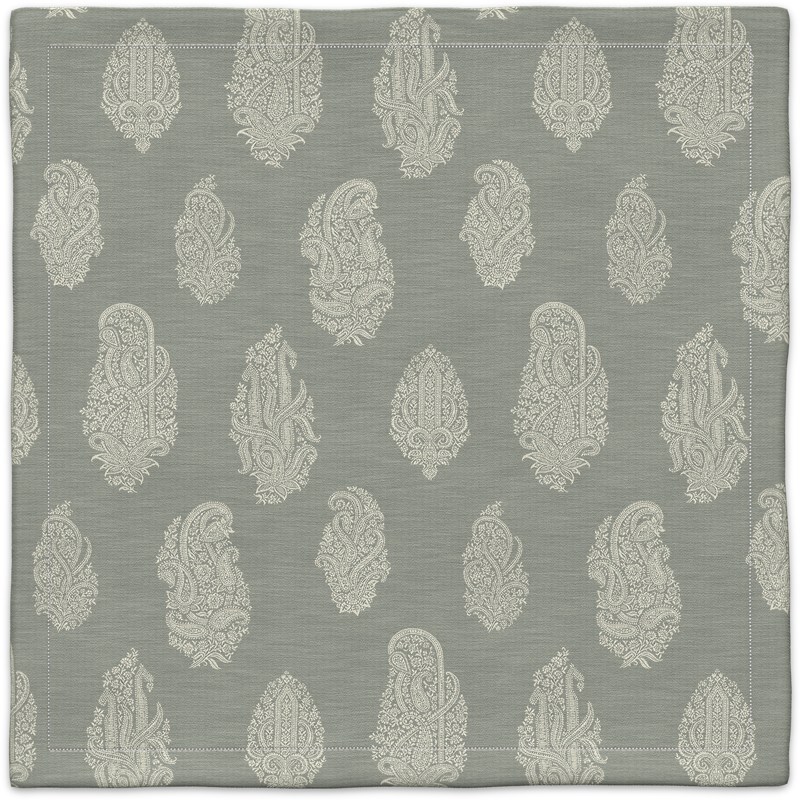 A gray and white rug with a paisley pattern.