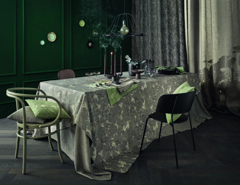 A table with a tablecloth and chairs.