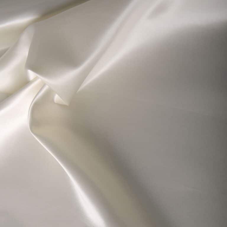 A close-up of white satin fabric.