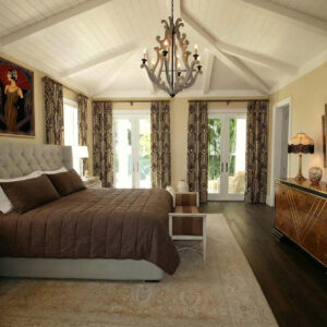 Ein Schlafzimmer mit einem großen Bett und einem Kronleuchter.