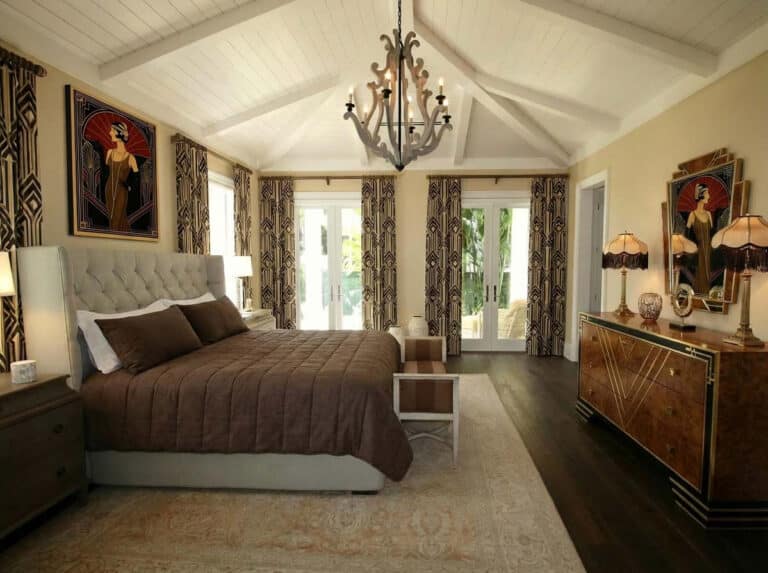 A bedroom with a large bed and a chandelier.