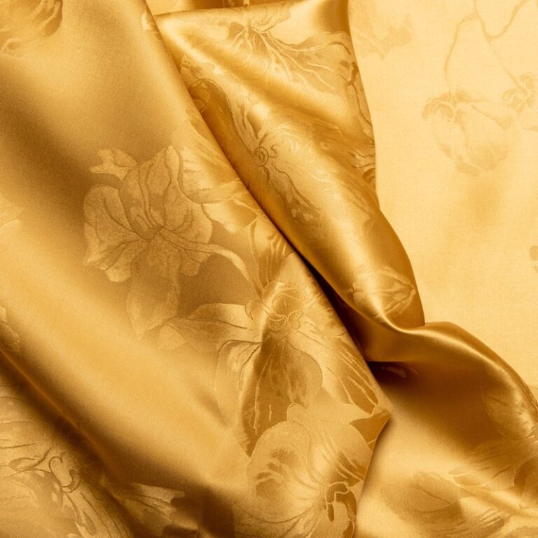A close-up of a gold-colored fabric.