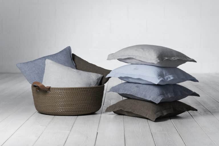 A stack of pillows on a wooden floor.