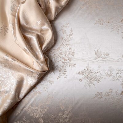 A close-up of a bed with a floral pattern.