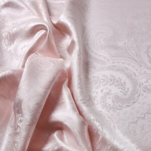 Eine Nahaufnahme eines rosa und weißen Stoffes.