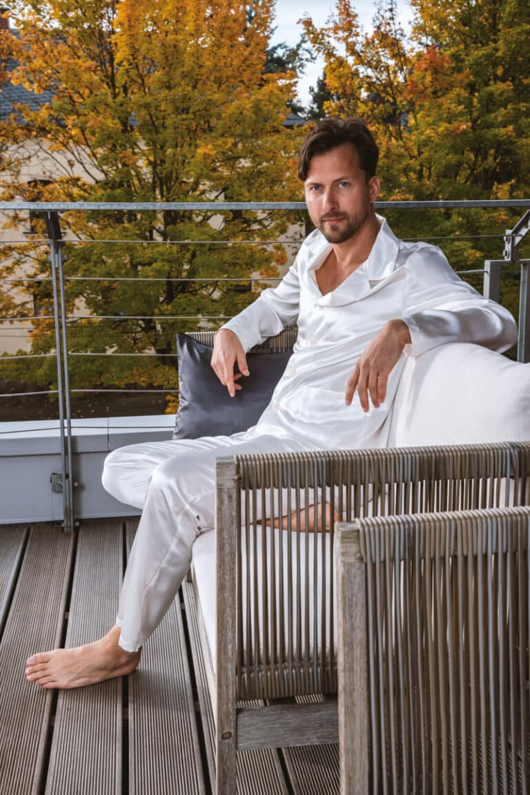 A man sitting on a wooden bench.