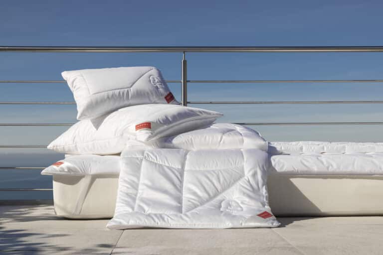 Ein Stapel Kissen, der auf einem Bett liegt.