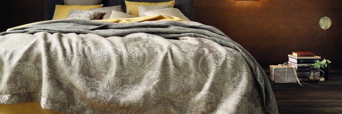 A bedroom with a large bed and a bedside table.