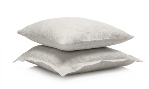 Two light grey, textured pillows are stacked against a white background, providing a beautiful accent on the Junco Classic Linen Bedding by Geniksa.