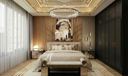 A luxurious bedroom with golden accents, a large chandelier, an Art Deco ceiling, and a bed with Lydia Pure Linen Bedding by Schlitzer Leinen. At the foot of the bed is a bench, while a striking wall mural featuring a woman's face completes the room.