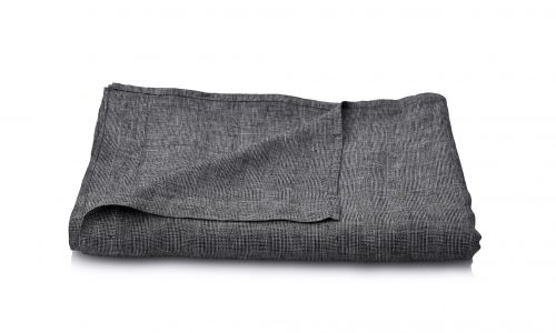 A neatly folded dark grey linen fabric on a white surface, with one corner slightly raised to reveal the texture and weave of the fabric.